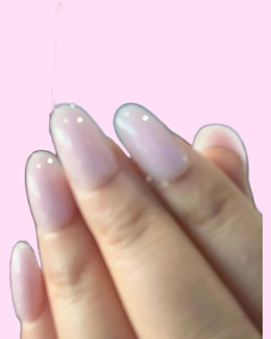 Short milky pink BIAB-style press-on nails showing a short natural nail shape
