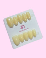 Yellow BIAB press on nails set of 10 on Aurelle Beauty card